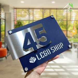 BIỂN SỐ NHÀ DECOR mẫu Lego Shop, Nền Inox 304 xước bạc + Mica Xanh Navy, Nội dung nổi.